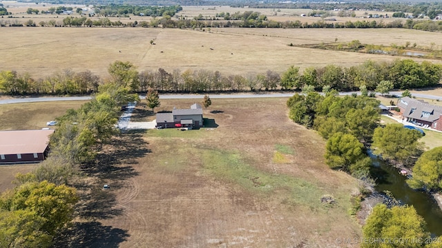 drone / aerial view featuring a rural view and a water view