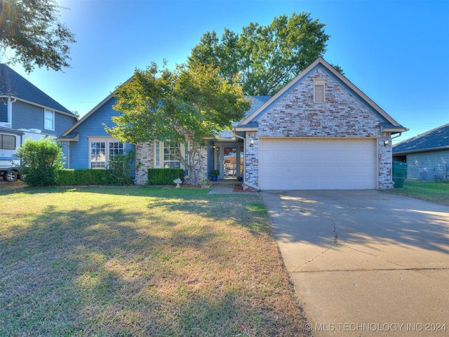 view of front of property with a front yard and a garage