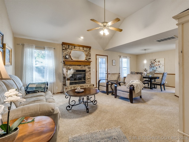 carpeted living room featuring ceiling fan, a brick fireplace, high vaulted ceiling, and a healthy amount of sunlight