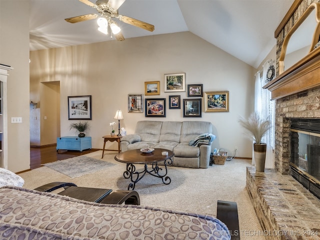 living room with a fireplace, ceiling fan, vaulted ceiling, and carpet flooring