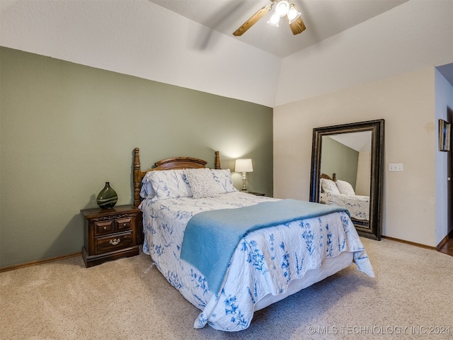 carpeted bedroom with ceiling fan and vaulted ceiling