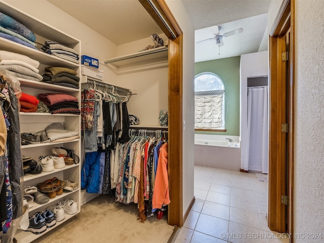 spacious closet with ceiling fan and light tile patterned floors