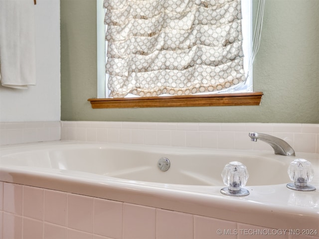 bathroom featuring a relaxing tiled tub