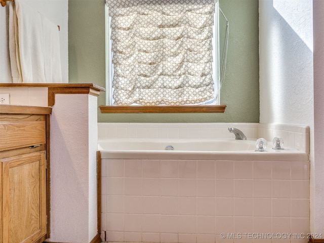 bathroom with tiled bath