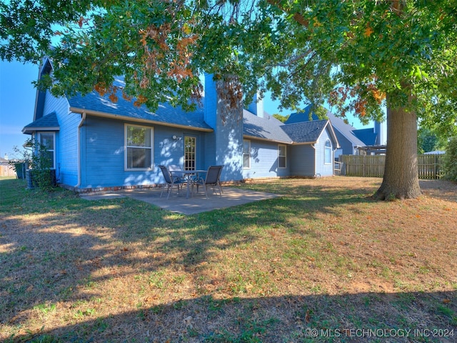 back of house with a yard and a patio area