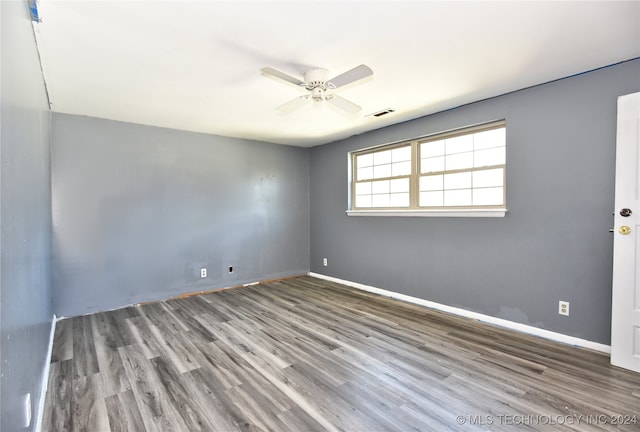 spare room with wood-type flooring and ceiling fan