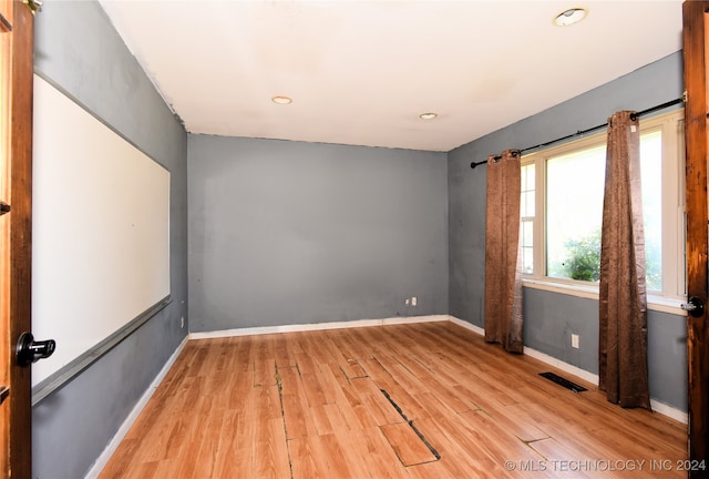 unfurnished room with light wood-type flooring