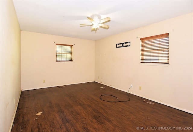 spare room featuring dark hardwood / wood-style flooring and ceiling fan