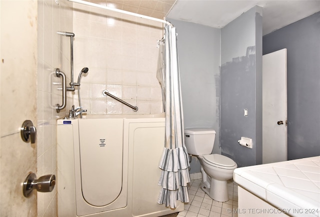 bathroom featuring toilet, curtained shower, and tile patterned floors