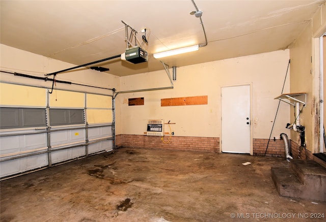 garage featuring a garage door opener and heating unit