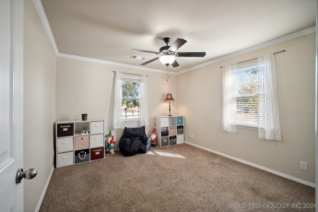 interior space with carpet flooring, ceiling fan, and crown molding