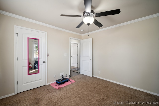 interior space with ceiling fan, crown molding, and carpet