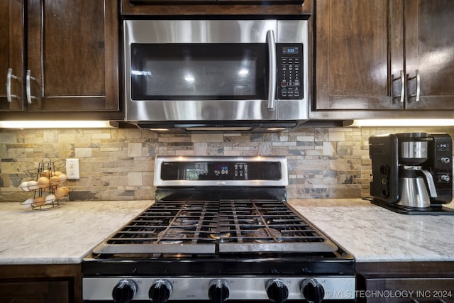 kitchen with backsplash, dark brown cabinetry, and stainless steel appliances