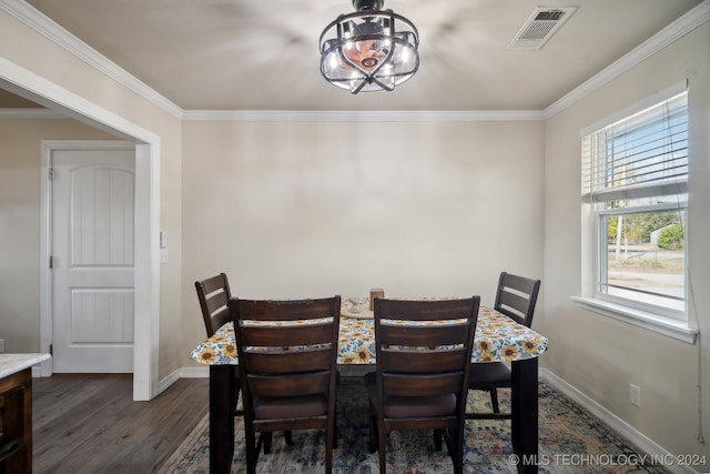 dining room with dark hardwood / wood-style floors, a wealth of natural light, and crown molding