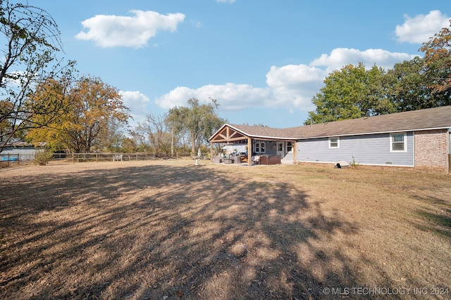 rear view of property with an outdoor hangout area and a yard