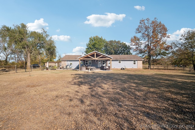 back of property with a patio and a lawn