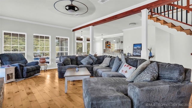 living room featuring light hardwood / wood-style floors, ornamental molding, and ceiling fan