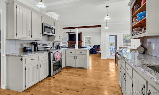 kitchen featuring pendant lighting, white cabinetry, light hardwood / wood-style flooring, appliances with stainless steel finishes, and backsplash