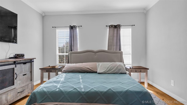 bedroom featuring light hardwood / wood-style flooring and ornamental molding