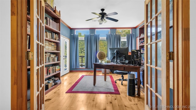 office area with ornamental molding, light wood-type flooring, and ceiling fan