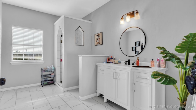 bathroom with vanity and a shower