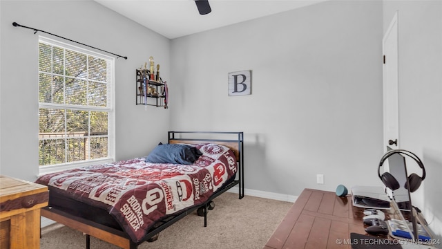 bedroom with ceiling fan and light colored carpet