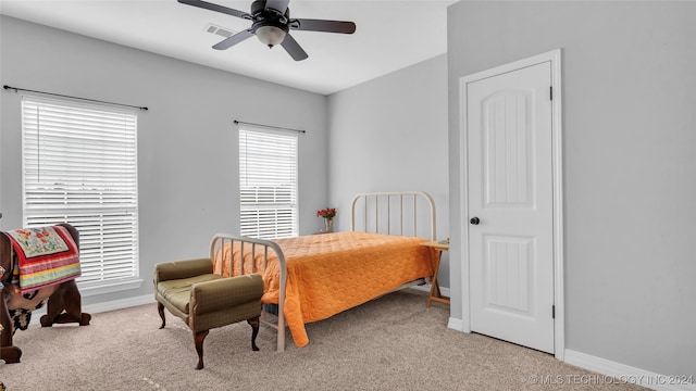 bedroom featuring light colored carpet and ceiling fan