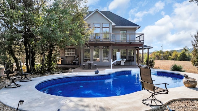 view of pool featuring a wooden deck and a patio