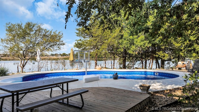 view of swimming pool featuring a deck with water view