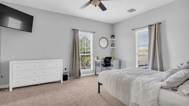 bedroom featuring light colored carpet and ceiling fan