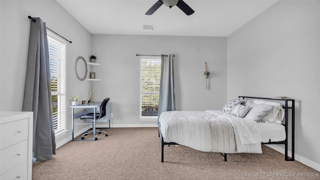 bedroom with ceiling fan and light carpet