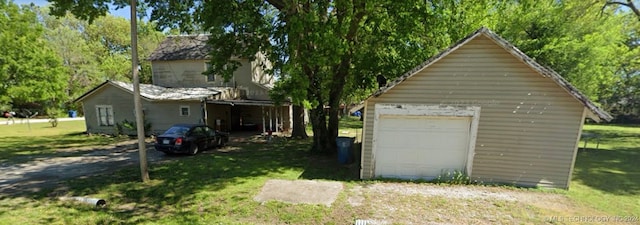 garage with a yard and a carport