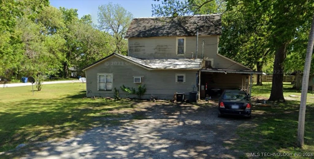 view of property exterior featuring a yard and a carport