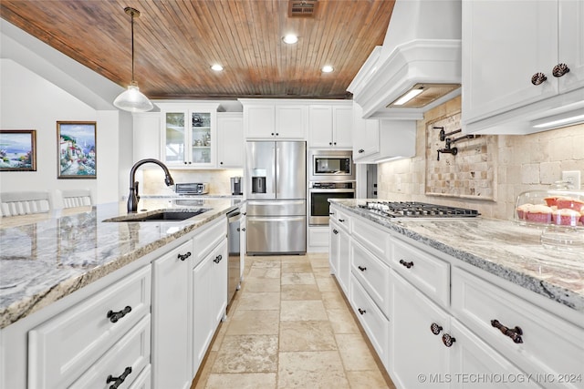 kitchen featuring appliances with stainless steel finishes, sink, hanging light fixtures, custom exhaust hood, and white cabinets