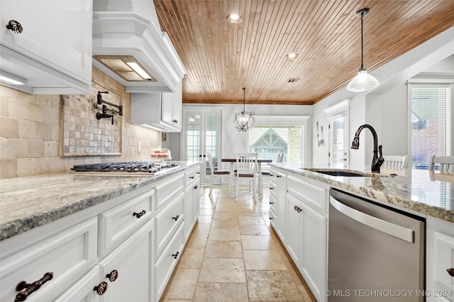 kitchen with appliances with stainless steel finishes, white cabinetry, sink, and pendant lighting