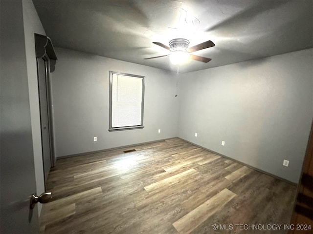 unfurnished bedroom featuring dark hardwood / wood-style floors and ceiling fan