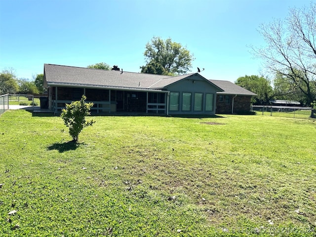 rear view of property with a lawn