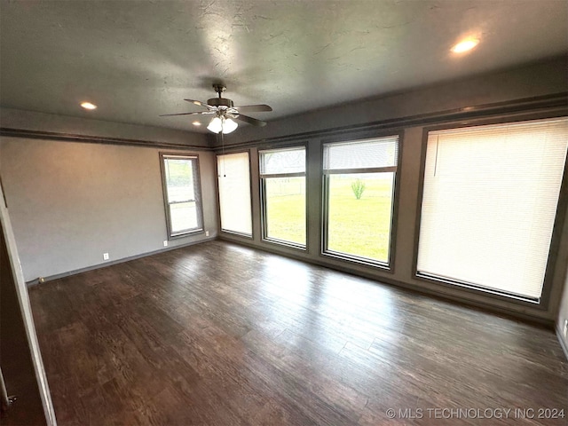 unfurnished room with ceiling fan and hardwood / wood-style flooring