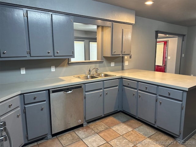 kitchen featuring kitchen peninsula, sink, gray cabinets, and stainless steel dishwasher