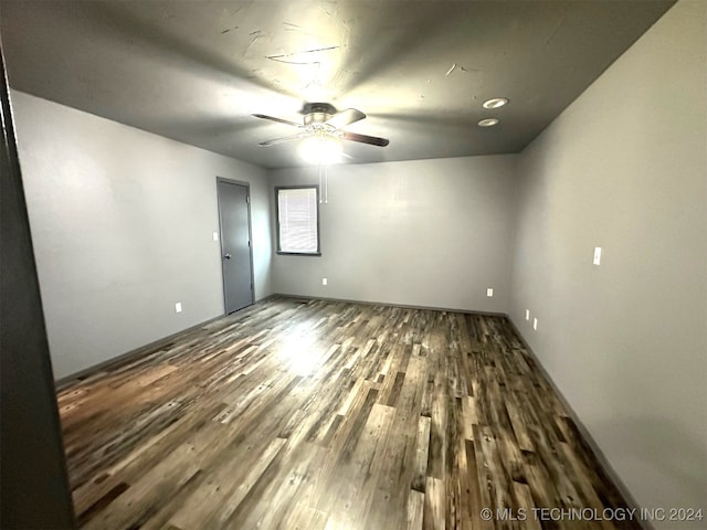 empty room with ceiling fan and wood-type flooring