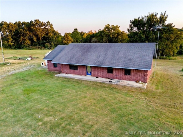 711 E Iowa, Whitefield, OK 74472 - property exterior at dusk with a lawn and a patio