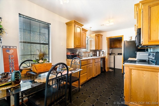 kitchen featuring backsplash, washer and clothes dryer, sink, dishwasher, and range