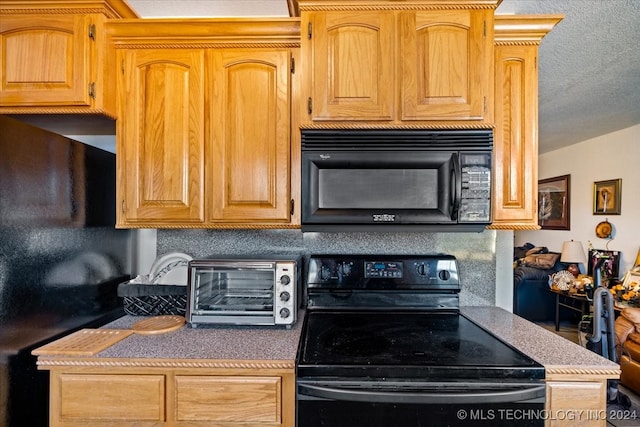 kitchen featuring a textured ceiling and black appliances