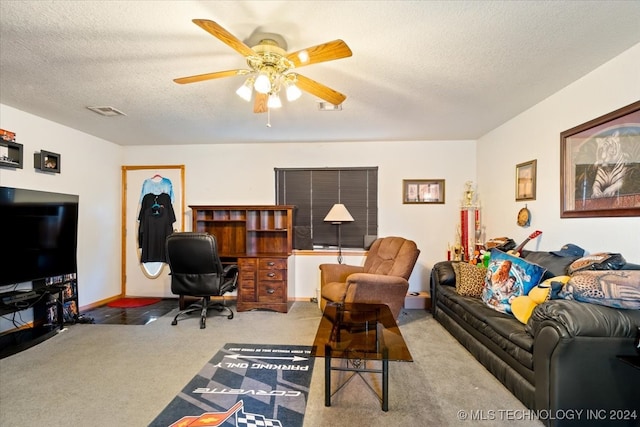 living room with ceiling fan, carpet floors, and a textured ceiling