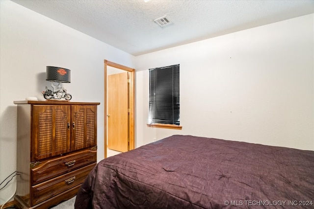 bedroom featuring a textured ceiling