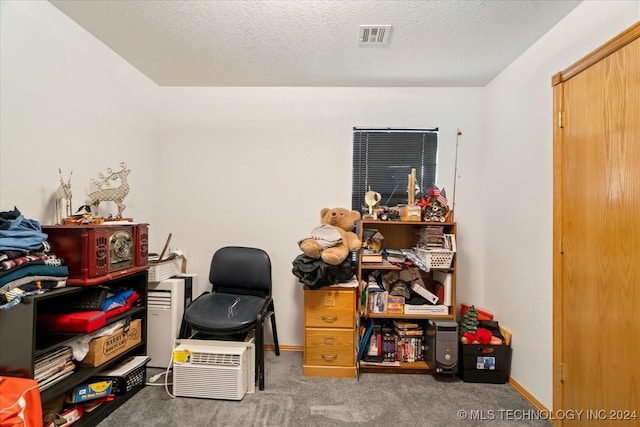 office space featuring dark carpet and a textured ceiling