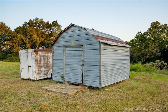 view of outbuilding with a lawn