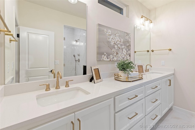 full bathroom with a stall shower, marble finish floor, a sink, and double vanity