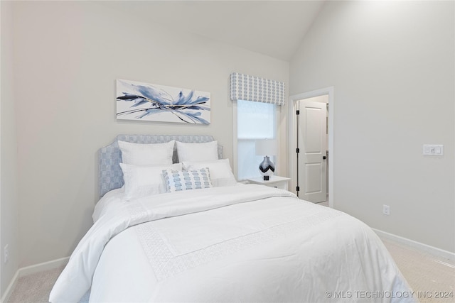 carpeted bedroom with vaulted ceiling