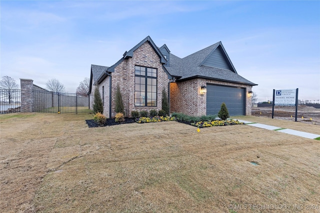 view of front of home featuring a front yard and a garage